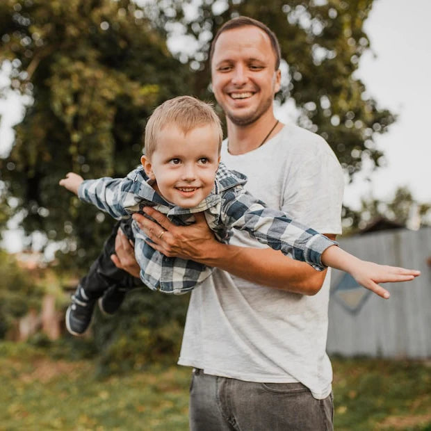 Father holding his child outdoors